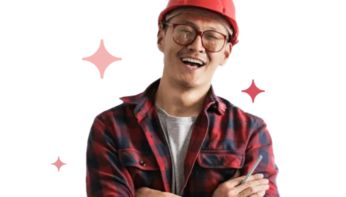 A happy contractor smiling with their hardhat on.