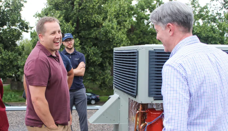 People laughing while talking about HVAC systems