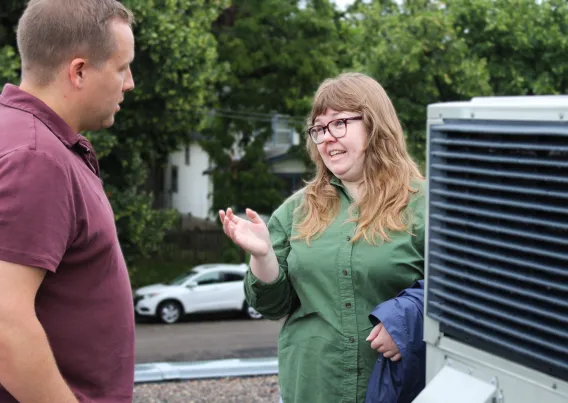 Two people have a conversation about an HVAC system.