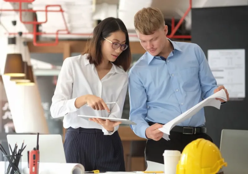 Two people looking at financial documents 