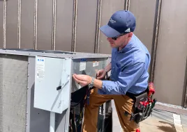 A HVAC technician performing maintenance on a commercial HVAC system. 