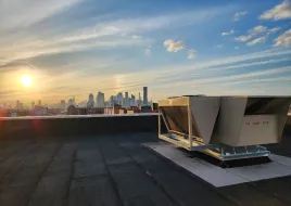 An image of HVAC equipment with the New York skyline in the horizon.  