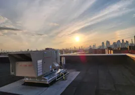 Two Daikin Rebel dual fuel heat pump rooftop units installed on a commercial building roof in Queens, New York
